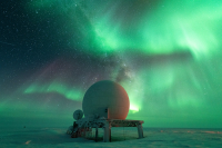 Auroras over the radome at South Pole Station. Photo by John-Michael Watson, courtesy of the NSF/USAP Photo Library.