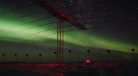 SuperDARN array with auroras in the background. Photo by Ted Lee.