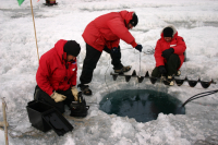 Researchers melt hole on Lake Bonney. Photo by John Priscu. Image courtesy of NSF/USAP Photo Library.
